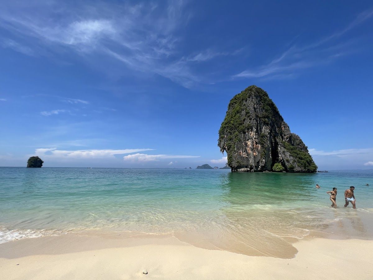 Phra Nang Cave Beach in Krabi with a dramatic limestone headland rising from clear turquoise shallows
