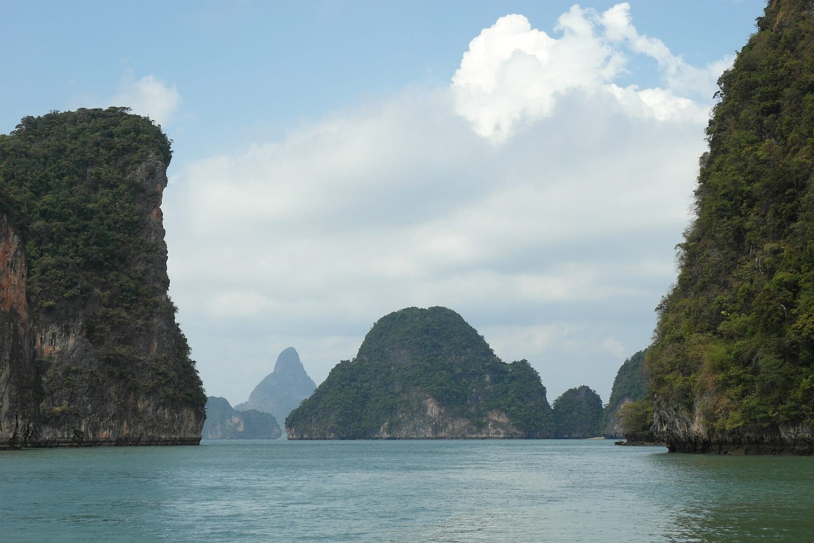 Longtail boats outside the narrow cliff gap into the Koh Hong lagoon in Krabi