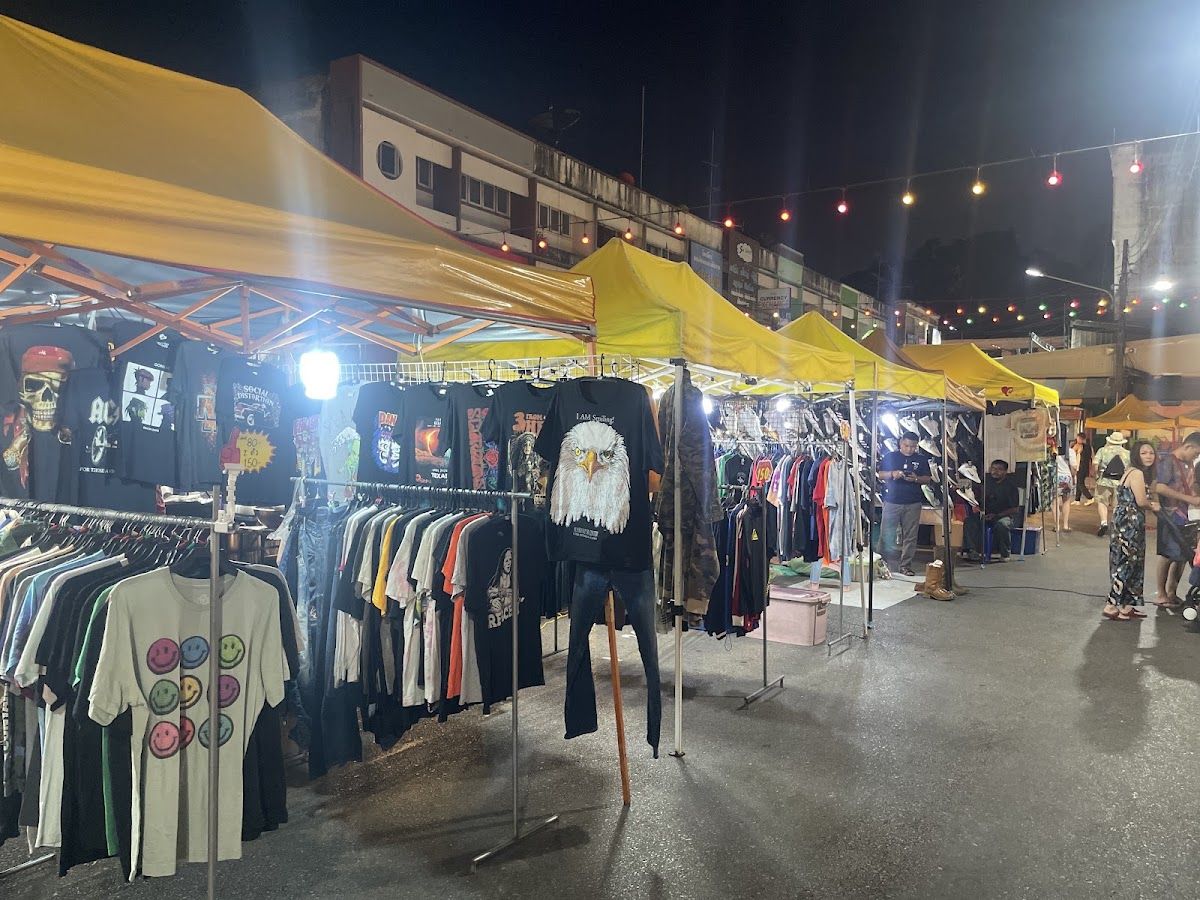 Clothing and street-food stalls lit up at night along Krabi Town's Walking Street on Soi Maharaj 8